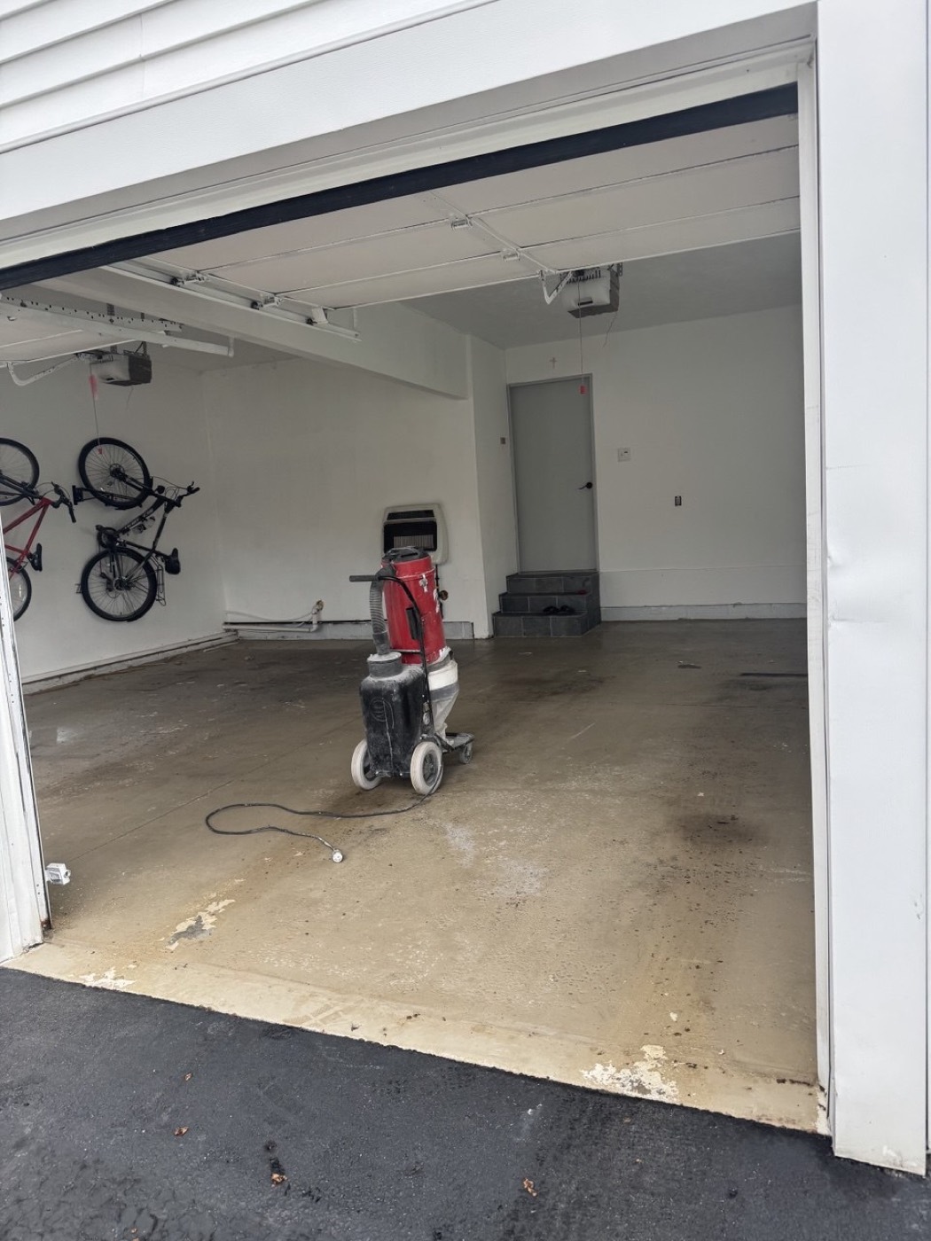 Bare, stained concrete garage floor before coating