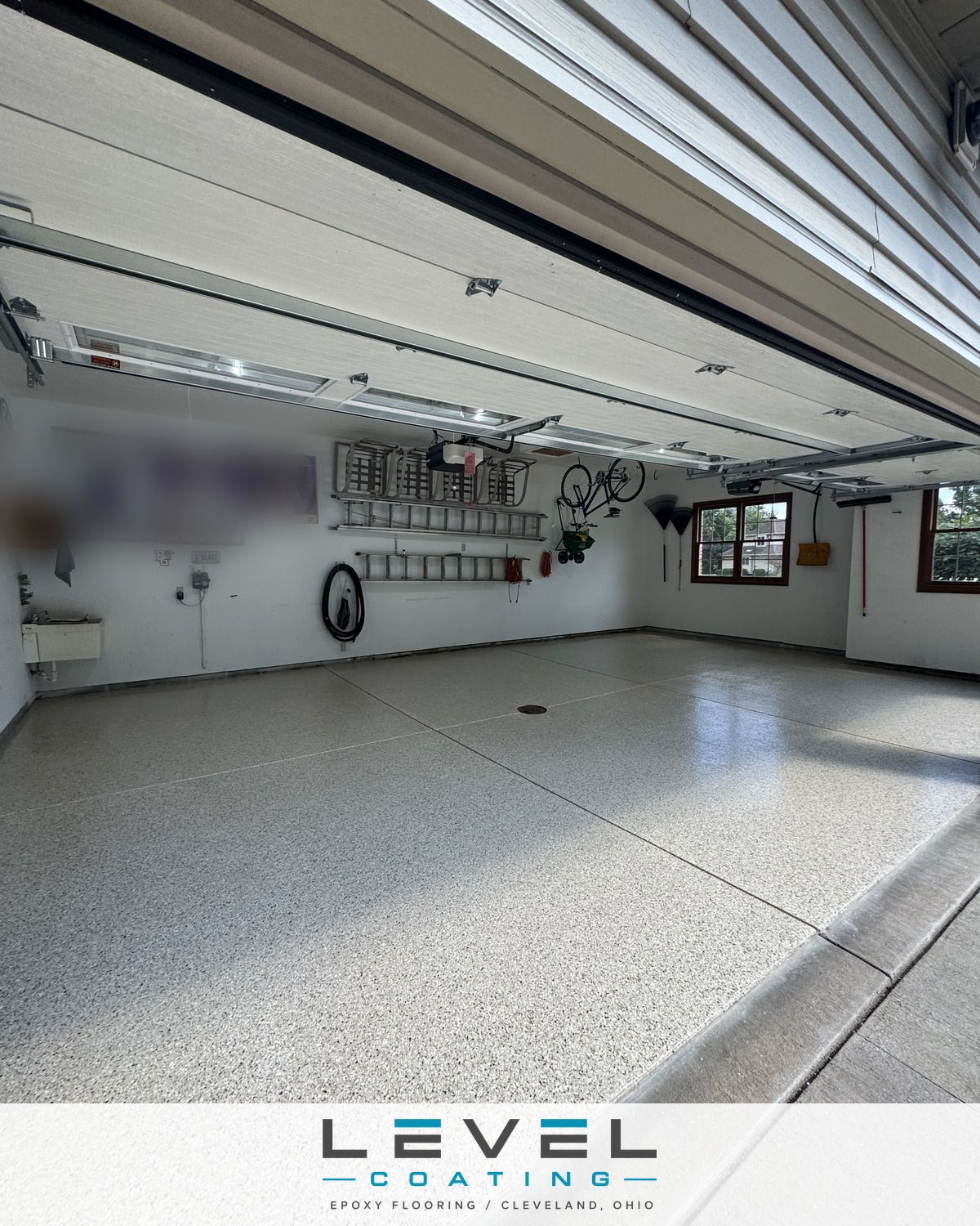 Gray and tan full-flake polyaspartic garage floor coated to the door edge - Broadview Heights, OH