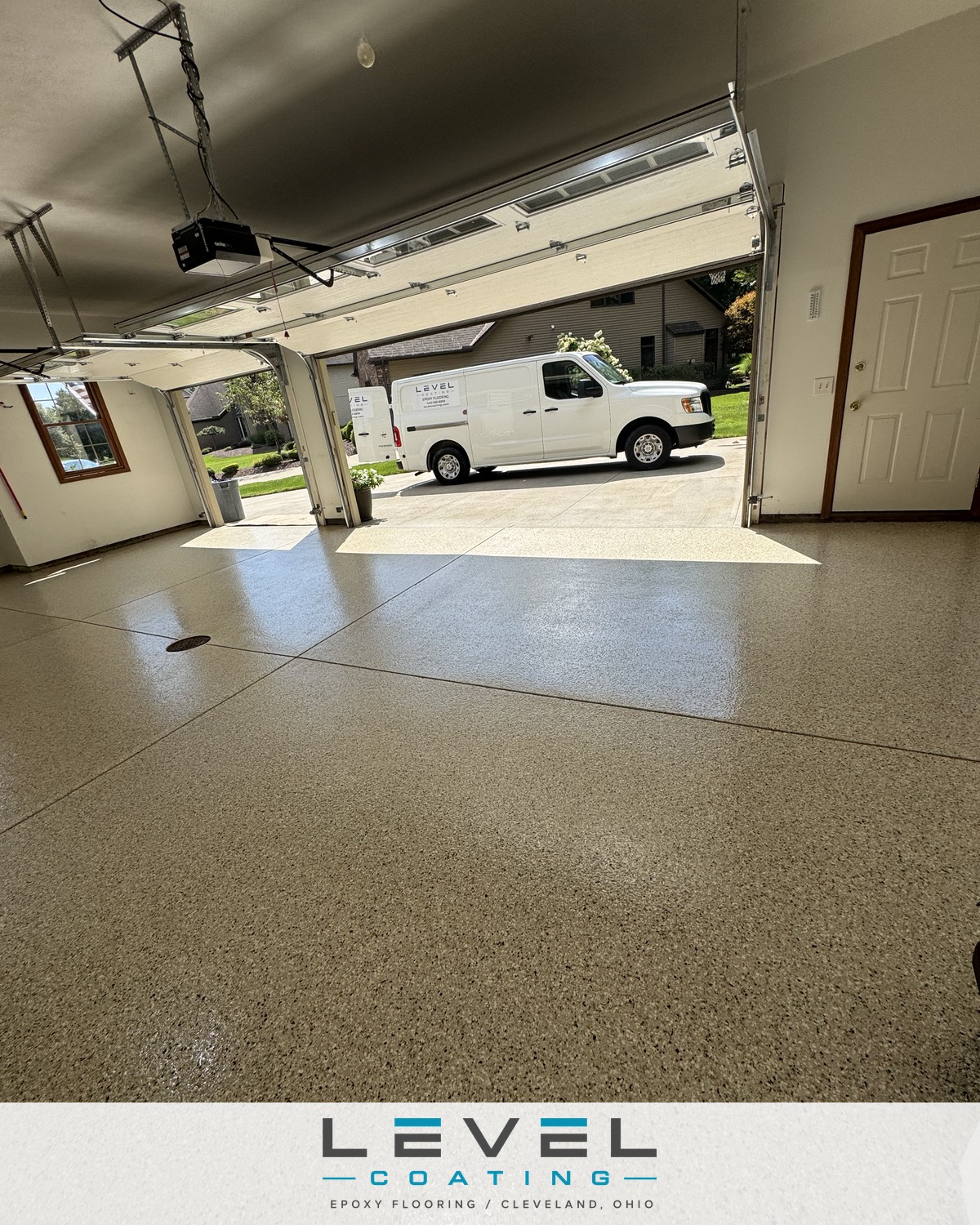 Three-car garage with a finished Level Coating flake floor and work van in the driveway - Broadview Heights, OH