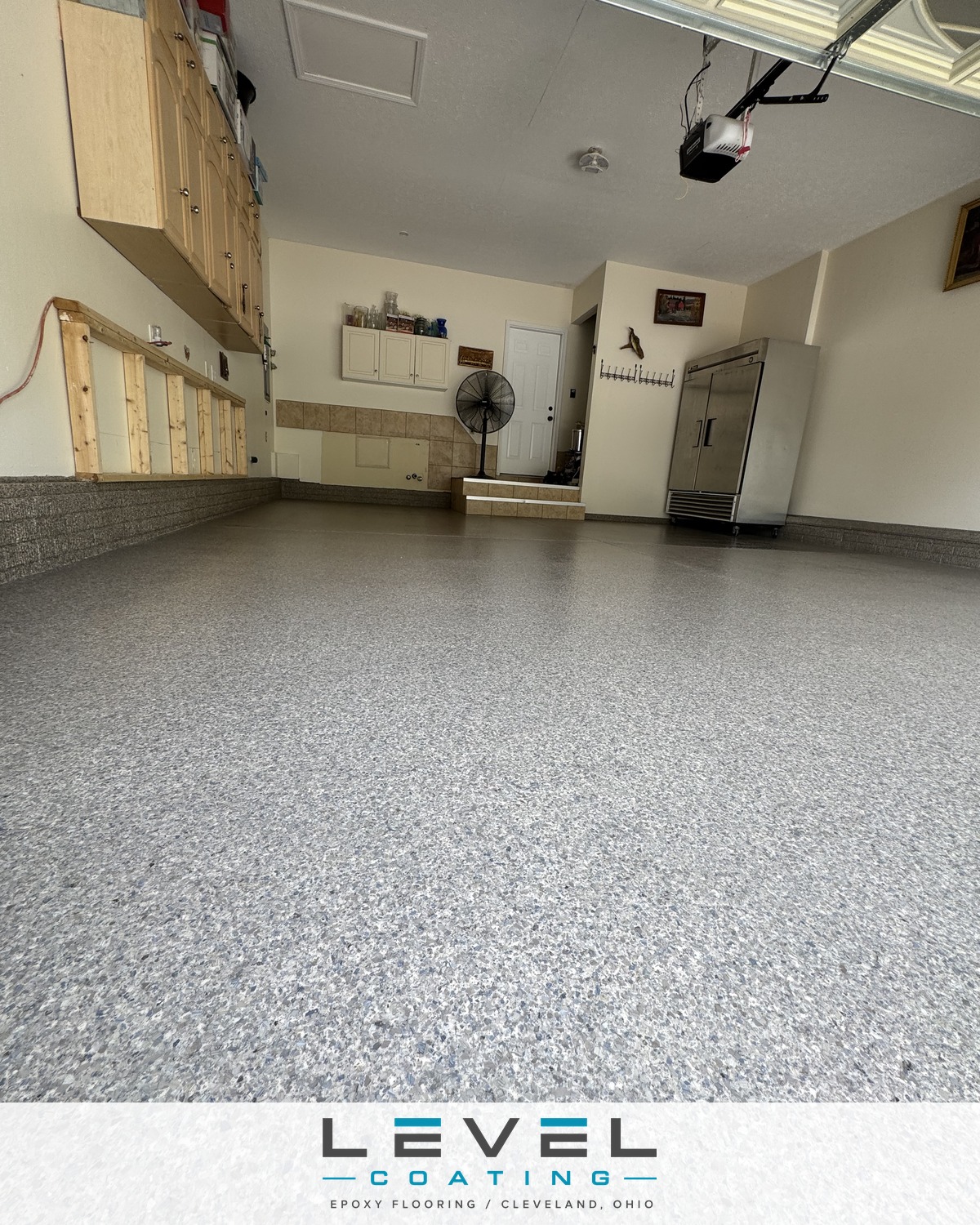 Two-car garage after a Level Coating flake floor with coated wall base - North Ridgeville, OH