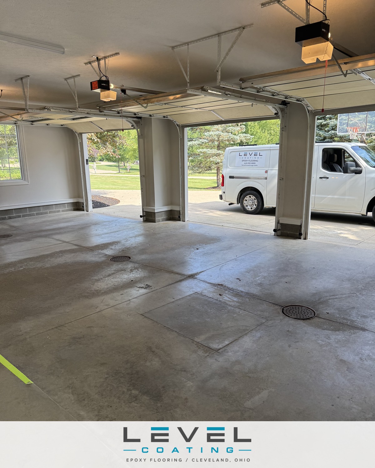 Cracked bare concrete in a three-car garage before coating - Solon, OH